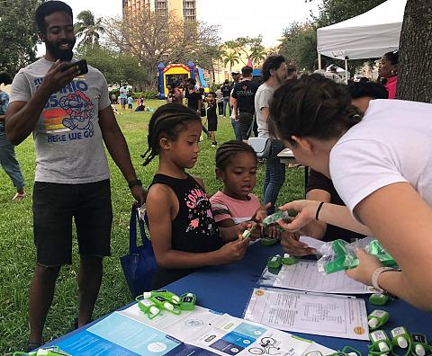 Public Outreach Officer, Hannah, talks with children about environmental benefits of biking